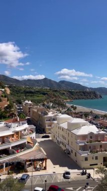 NERJA, İspanya - 22 Mart 2025: Işıldayan deniz ve büyüleyici şehrin muhteşem manzaraları, 22 Mart 2025 tarihinde İspanya 'nın Nerja kentinde nefes kesen kıyı manzaraları ve pitoresk bir atmosfer sunuyor.