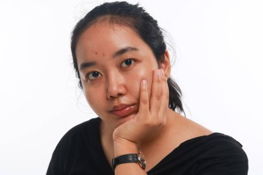 Beyaz arka planda makyajı olmayan genç Asyalı kadın..