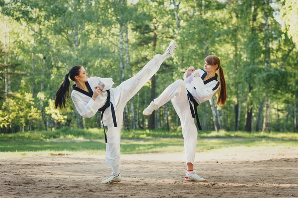 Two karate woman fighting on outdoor