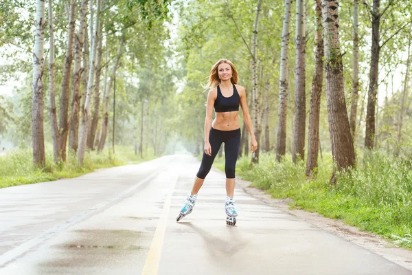 Roller skating sporty girl in otdoor. Caucasian woman in outdoor fitness activities.