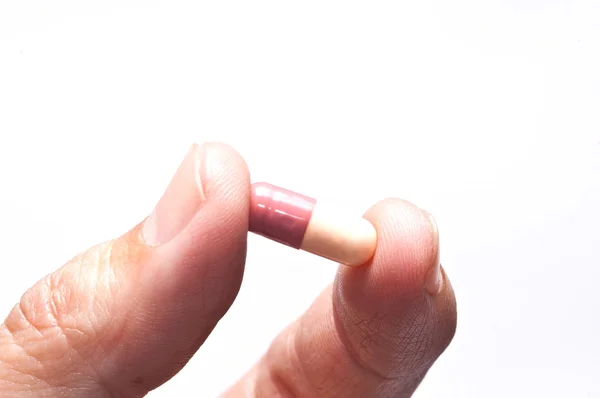 Hand holding a pill capsule. — Stock Photo, Image