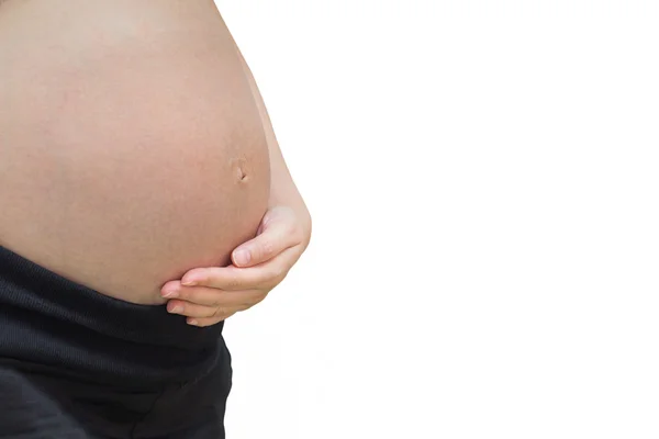 Hasa egy terhes nő, elszigetelt fehér háttér — Stock Fotó