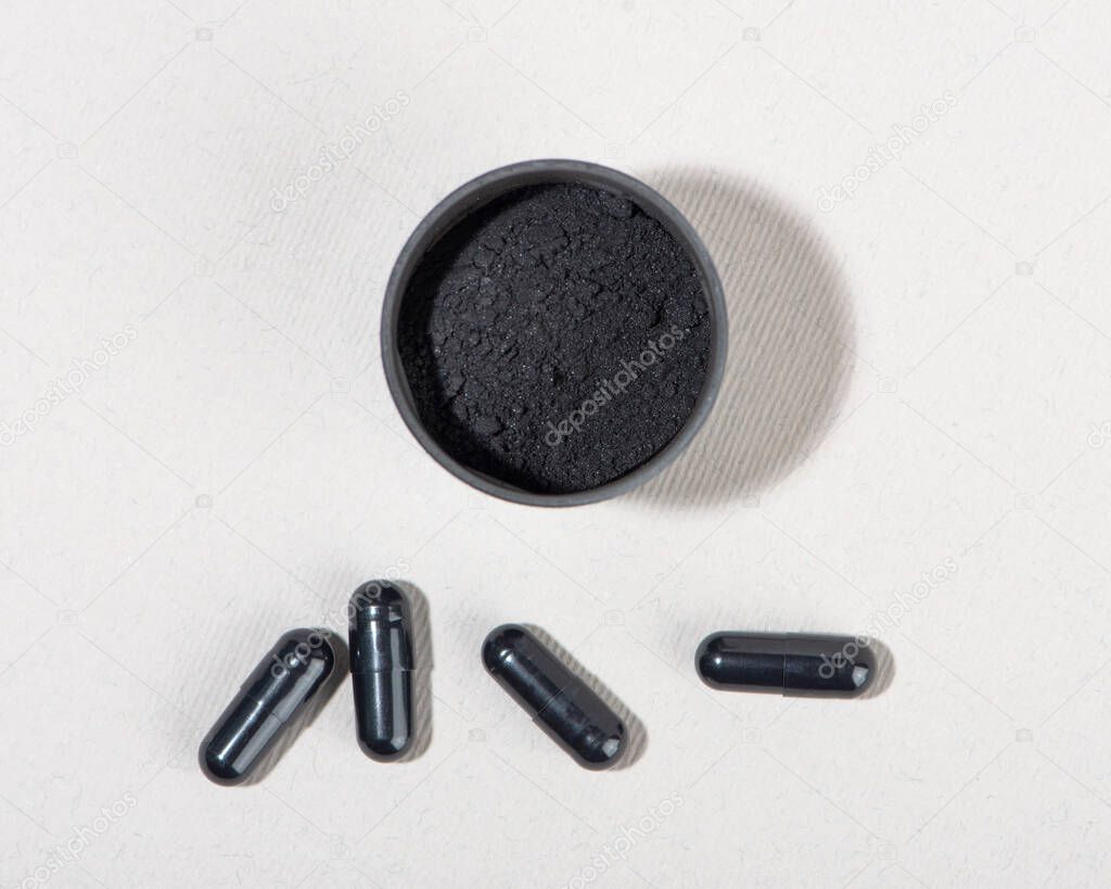 Activated charcoal powder for facial mask. Natural beauty treatment and spa. Beauty concept. Close up. Top view.