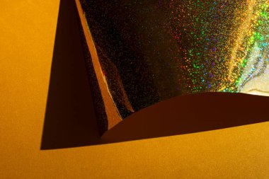 Altın holografik kağıtlı kompozisyon. Geçmişe dönük fütüristik. Seçici odak.