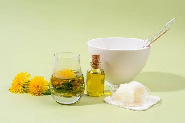 Dandelion (Taraxacum) infusion, oil and plant butter for making facial mask. Home made beauty product. DIY dandelion facial mask recipe. Natural beauty treatment.