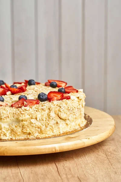 Cake napoleon. Board with delicious tasty homemade cake on table. Wooden background