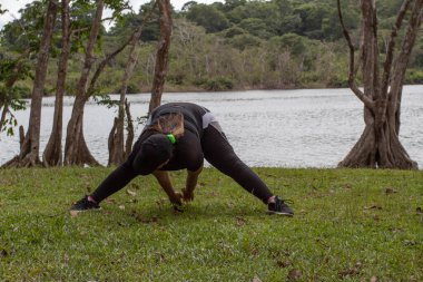 Gölün kıyısında uzanan genç bir kadın.