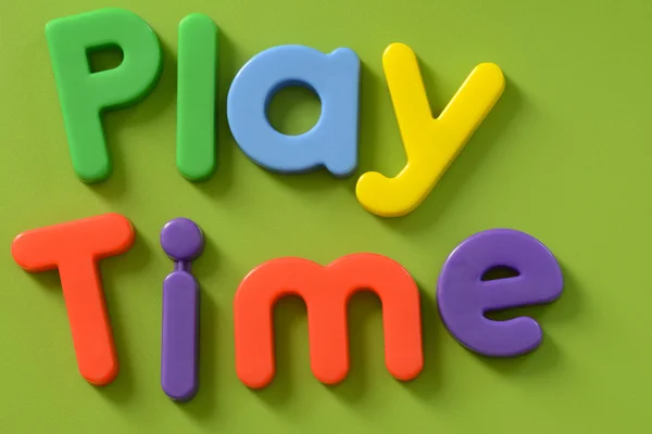 Words Play Time, in colorful plastic letters on green background