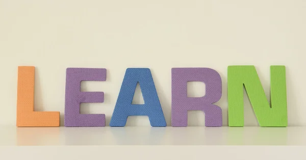 Word LEARN, en letras mayúsculas coloridas de juguetes de espuma —  Fotos de Stock