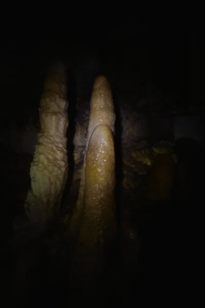 Stalactites in dark in a cave — Stock Photo, Image