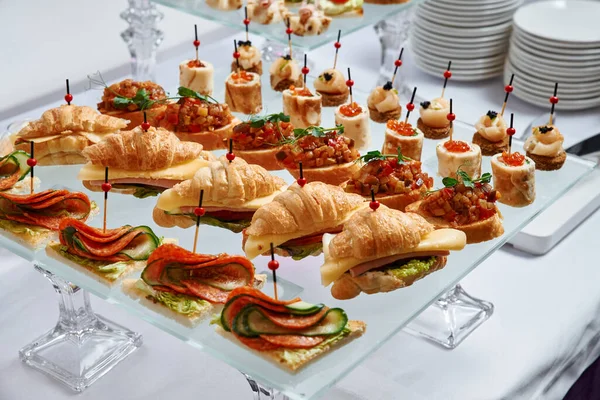 Yemek servisi. Farklı abur cubur ve tatlılarla dolu ziyafet masası 