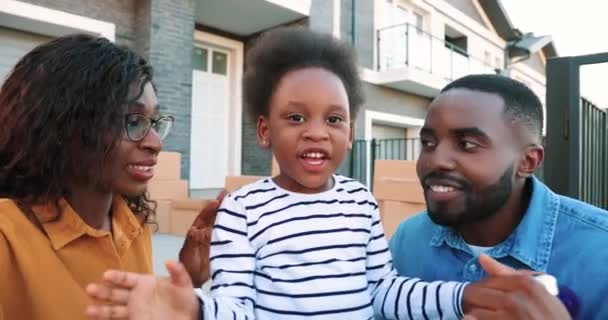 POV de la jeune famille afro-américaine avec une petite fille mignonne souriante et parlant à la caméra tout en visionnant en plein air. Sourit heureux mère, père et petite fille bavarder via webcam. Vidéochat. — Video