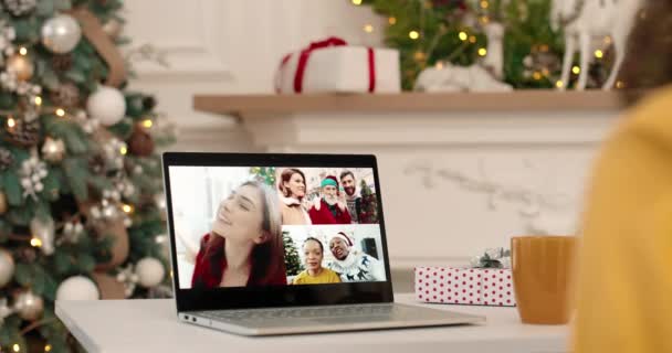 Close up of laptop screen with multiple video call with mixed-races friends and relatives in festive mood on New Years Eve talking in good mood. Holiday season concept. Winter season — Stock Video