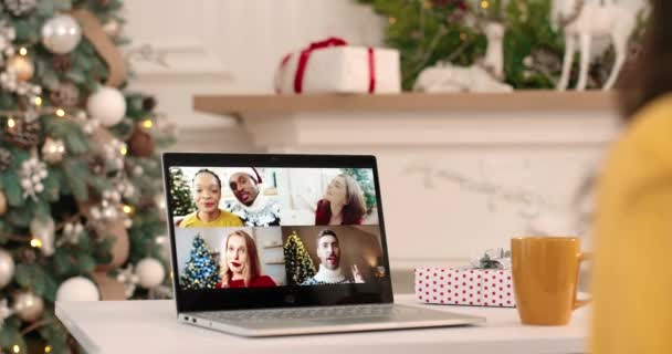 Close up. Over shoulder view of computer monitor with multiple video call between happy pretty female, African American couple and friends speaking on New Year online. Video chat concept. Xmas mood — Stock Video