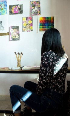a woman learning activity at home, painting with watercolor