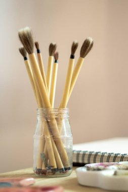 brushes and notebook ready to paint with watercolor