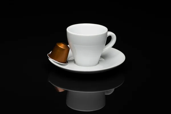 Cup of coffee with capsules — Stock Photo, Image