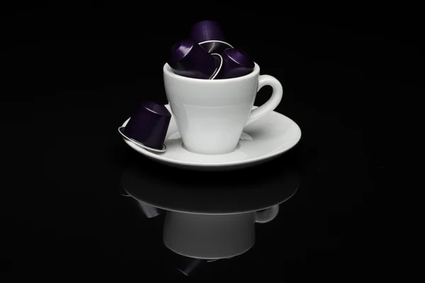 Cup of coffee with capsules — Stock Photo, Image