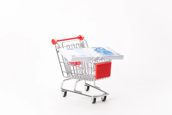 Caddy for shopping with money stack — Stock Photo, Image