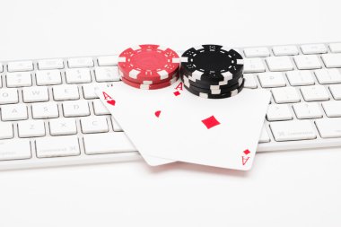 Poker cards and chips on web keyboard clipart