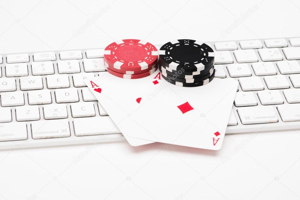 Poker cards on web keyboard on white background