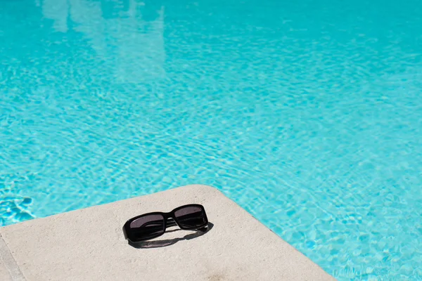Swimming pool and sunglasses — Stock Photo, Image