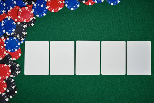 Poker chips on table with blank cards — Stock Photo, Image