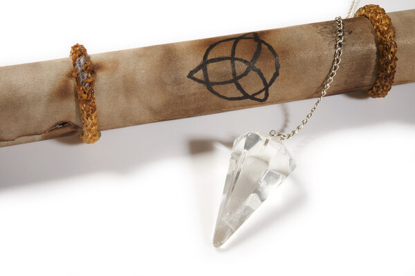 Old parchment with crystal pendulum