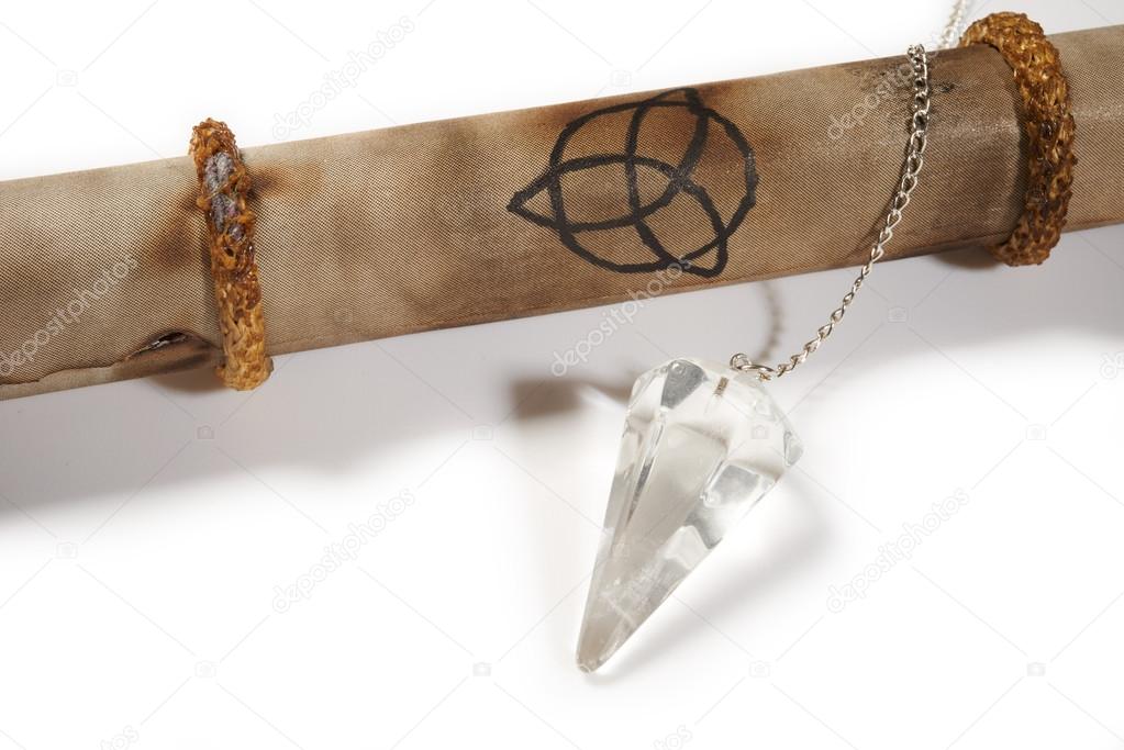 Old parchment with crystal pendulum