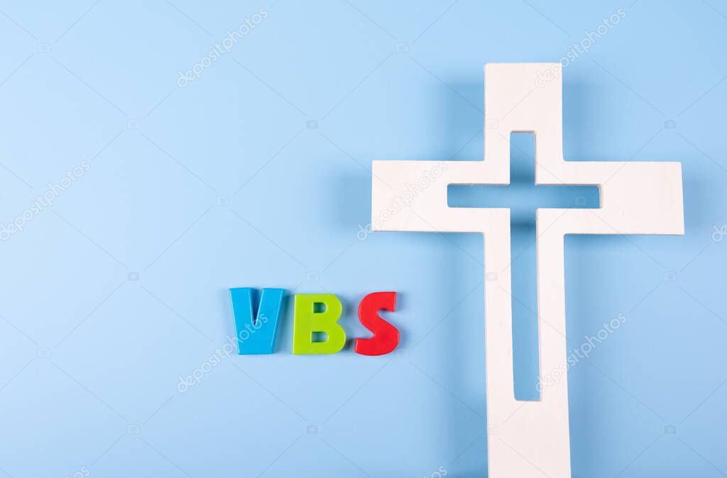 Church background with wood cross next to Abbreviation 