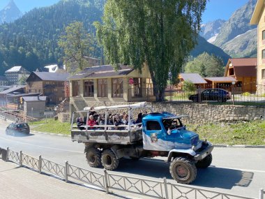 Dombay, Rusya - 15 Ağustos 2020: Ulaşılması zor bölgede turist taşıyan off-road yolcu kamyonu, Dombay, Rusya