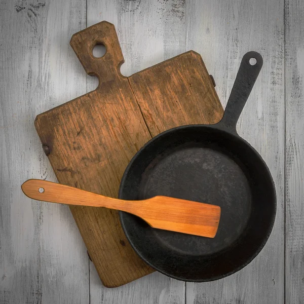 Cutting board, pan and wooden spatula — Stock Photo, Image