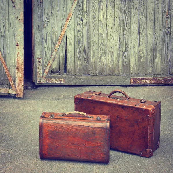 Two travelling suitcases stand near a garage — Stock Photo, Image