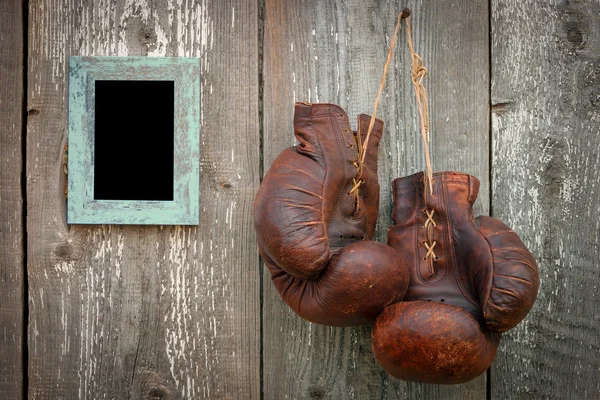 Old boxing gloves and frame for photo — Stock Photo, Image