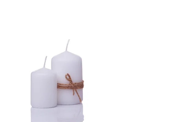 Two white candles of different sizes, one wrapped in jute rope, isolated — Stock Photo, Image