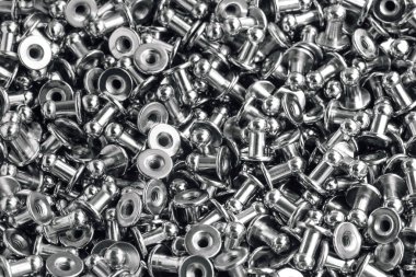 macro black and white background of sewing accessories-grommet, rivet, snap, button