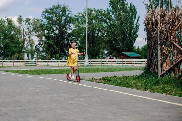 Ritratto completo di una ragazza su uno scooter, passatempo sano, attività sportiva familiare — Foto Stock