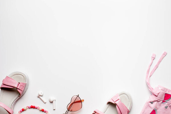 Border design flat lay with copy space. Beach, summer holiday girls accessories on white background.