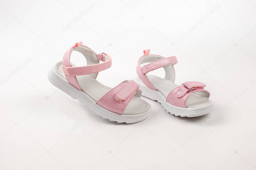 Pink insulated sandals. Childrens pink sandals with white soles and Velcro fasteners isolated on a white background. Fashionable childrens shoes for children