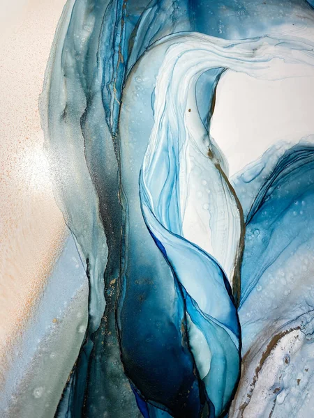 Abstract blue-green background with gold, beautiful smudges and stains made with alcohol ink and metallic pigment. Fragment of art with turquoise texture resembles sea, watercolor or aquarelle.