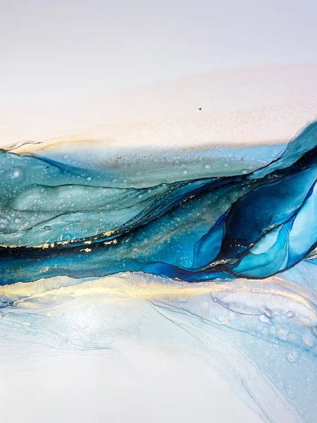 Abstract blue-green background with gold, beautiful smudges and stains made with alcohol ink and metallic pigment. Fragment of art with turquoise texture resembles sea, watercolor or aquarelle.