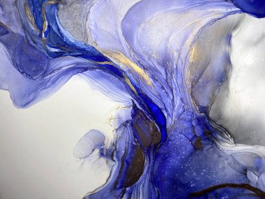 Abstract blue background with beautiful smudges and stains made with alcohol ink and gold pigment. Fluid art with blue texture resembles sea, ocean, watercolor or aquarelle painting.