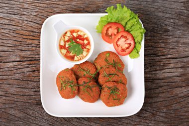 Kızarmış deniz balığı ezmesi topları tatlı ve baharatlı sosla servis edilir, menüde kullanılacak yemek fotoğrafçılığı. 