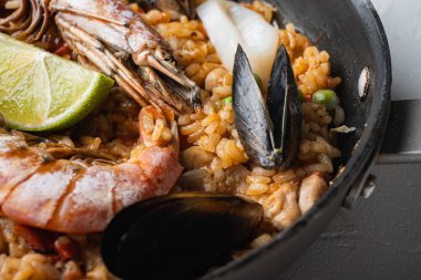 Paella tavada pişmiş beyaz desenli arka plan, yemek fotoğrafı..