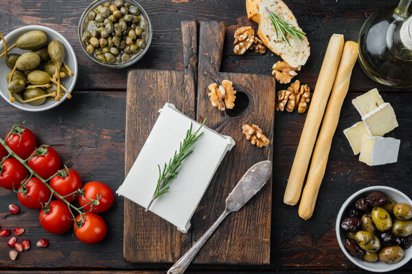 Ingredients for traditional greek salad set, on dark wooden background, top view