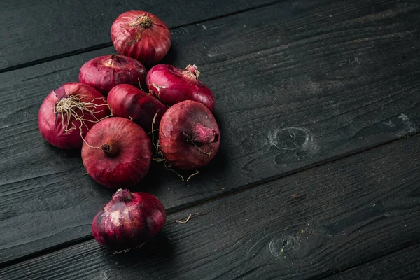 stock image Red onion, on black wooden table background  with copy space for text