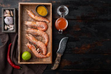 Mango turşusu. Çiğ kral karidesleri üzerine çiğ deniz kabuğu. Ahşap kutuda, eski, ahşap masa zemininde.