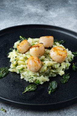 Kavrulmuş deniz tarakları ızgara yemek, gri arka planda.