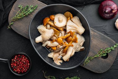 Turşulu mantar seti, siyah arka planda, üst görünüm düz yatıyordu.