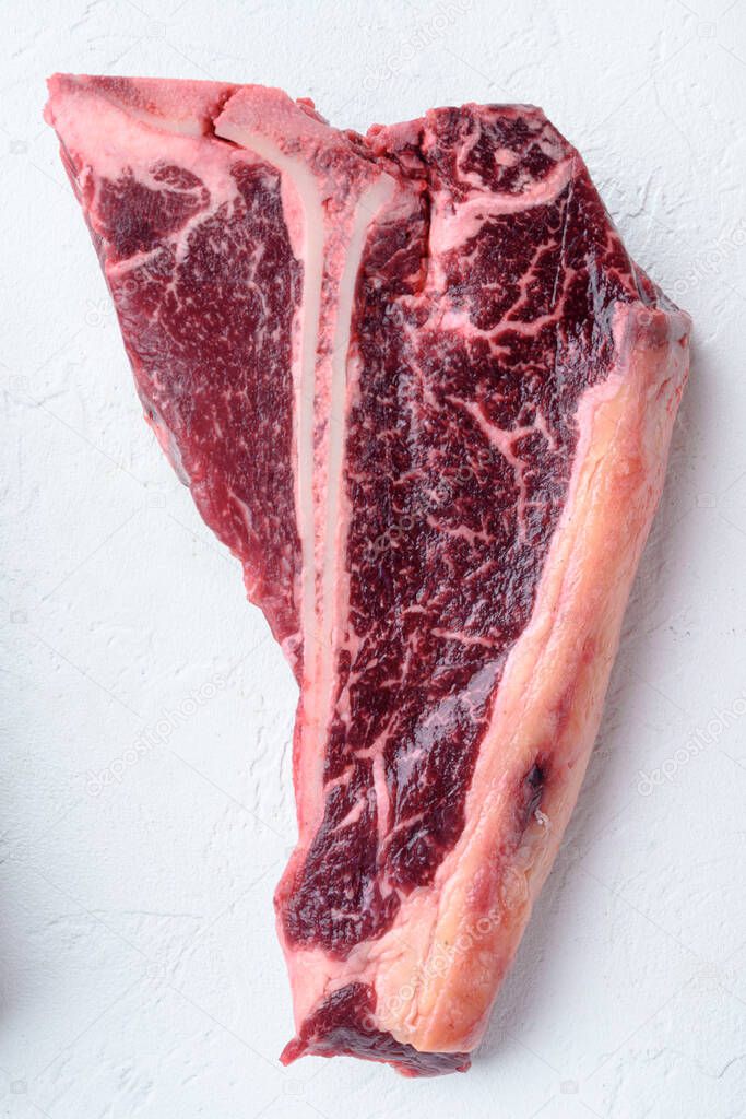 T bone steak raw set, on white stone  background, top view flat lay